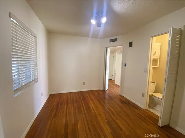 a view of a room with wooden floor and windows