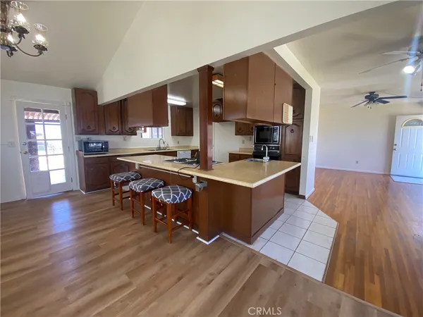 a kitchen with a sink cabinets and wooden floor