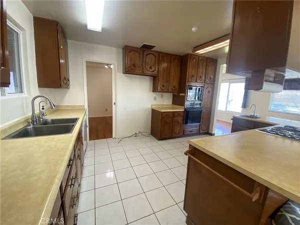 a kitchen with a sink a stove and refrigerator