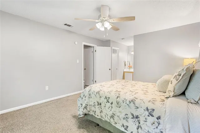 a bedroom with a bed and a ceiling fan
