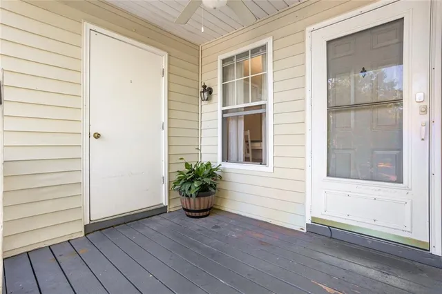 a view of front door with wooden floor and a window