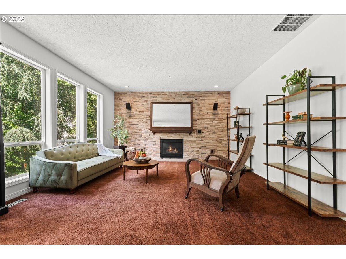 12431 Southwest 55th Place Portland, OR 97219 - Photo 9 of 40 a living room with furniture and a fireplace