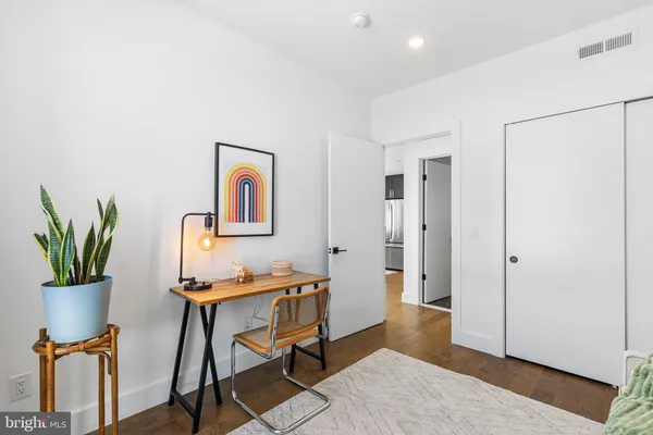 a view of a workspace with furniture and a potted plant