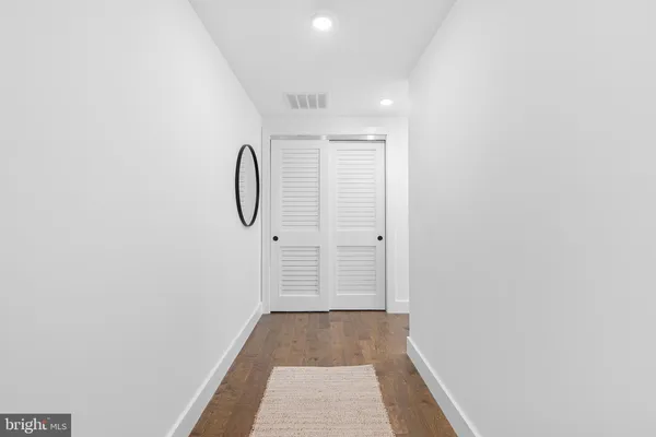 a view of room with window and wooden floor
