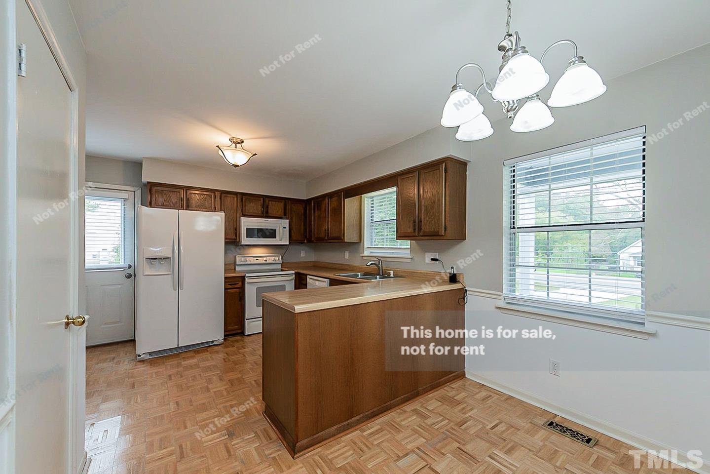 917 Horton Road Durham, NC 27704 - Photo 2 of 17 a kitchen with stainless steel appliances granite countertop a refrigerator a sink dishwasher a stove and a refrigerator with wooden floor