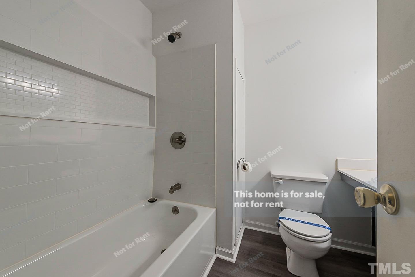917 Horton Road Durham, NC 27704 - Photo 14 of 17 a white toilet sitting next to a bath tub