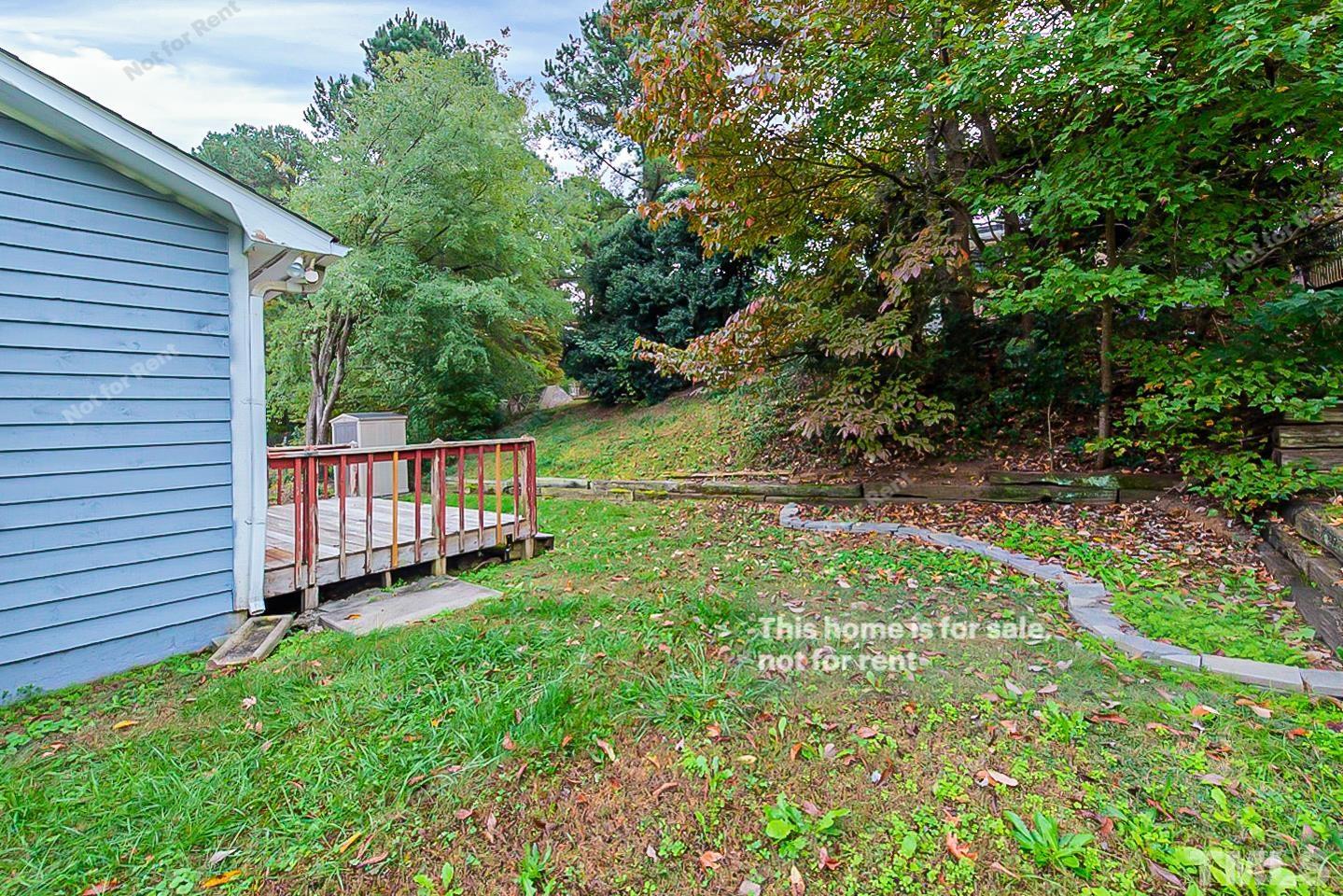 917 Horton Road Durham, NC 27704 - Photo 15 of 17 a backyard of a house with a garden and deck