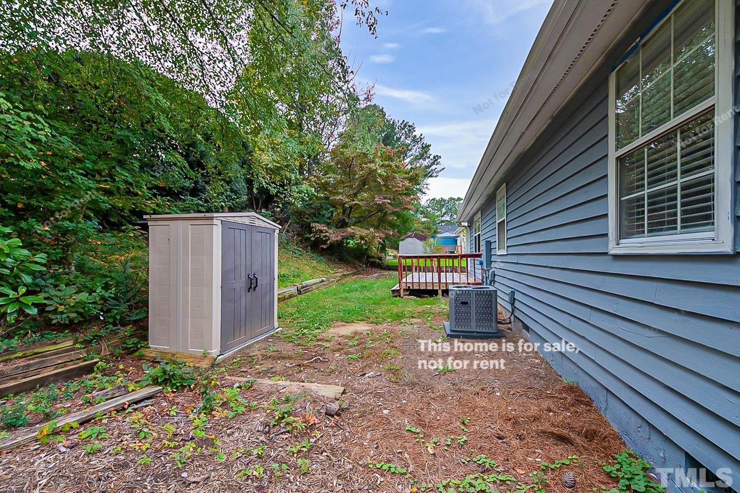 917 Horton Road Durham, NC 27704 - Photo 16 of 17 a view of a backyard with plants and large tree