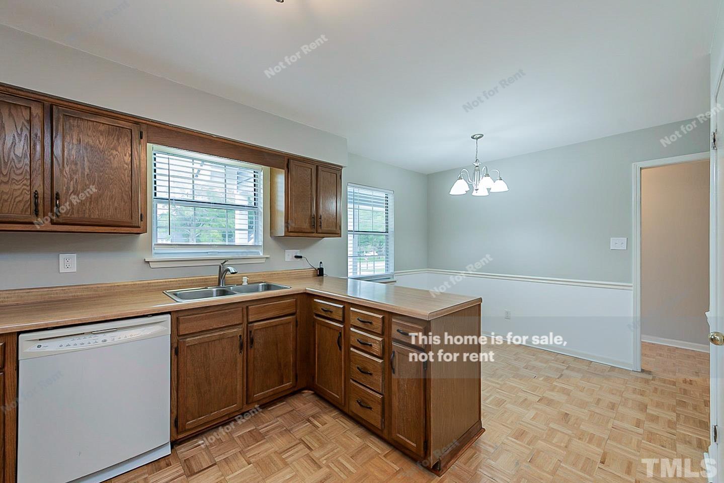 917 Horton Road Durham, NC 27704 - Photo 7 of 17 a kitchen with a sink a stove cabinets and a window