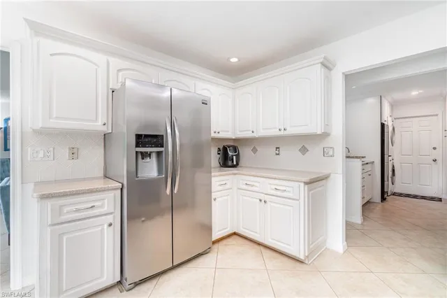 a kitchen with stainless steel appliances a refrigerator sink and cabinets