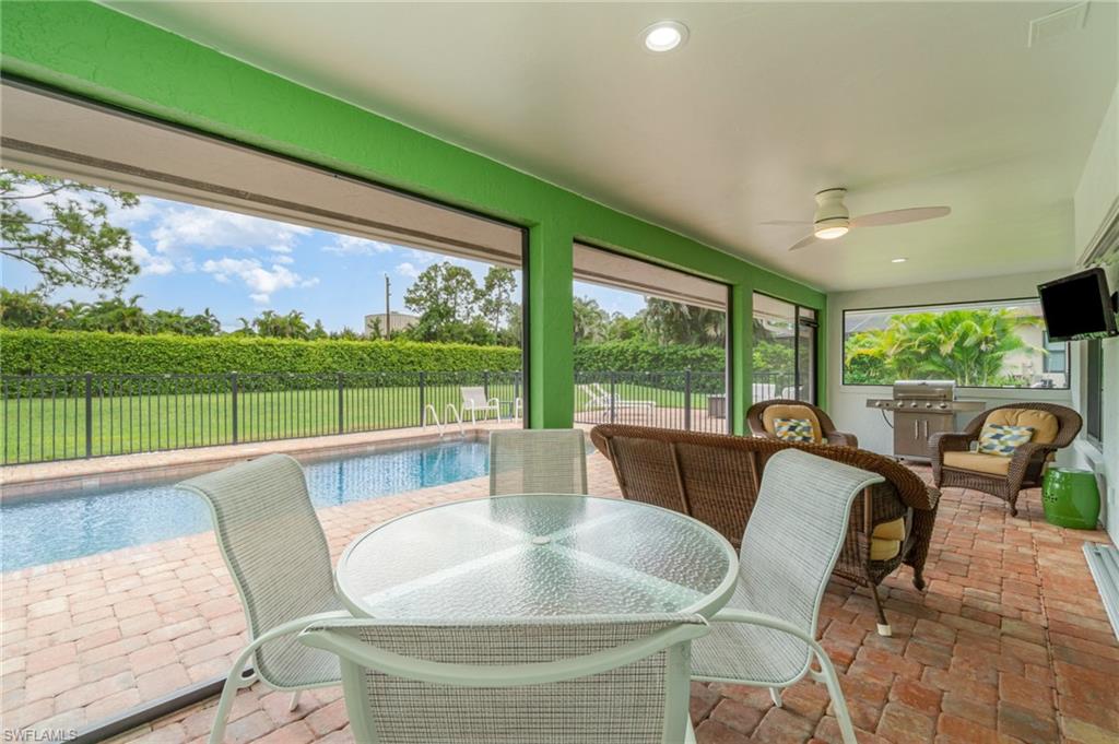 1933 Countess Court Naples, FL 34110 - Photo 21 of 25 a dining room with furniture and a floor to ceiling window