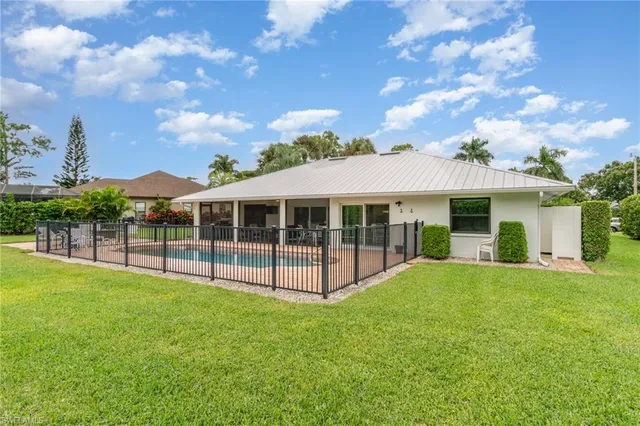 a view of a house with a yard and sitting area
