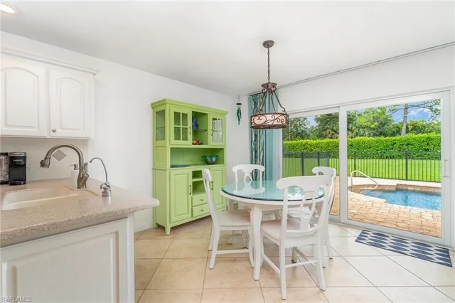 a dining room with furniture a chandelier and a rug