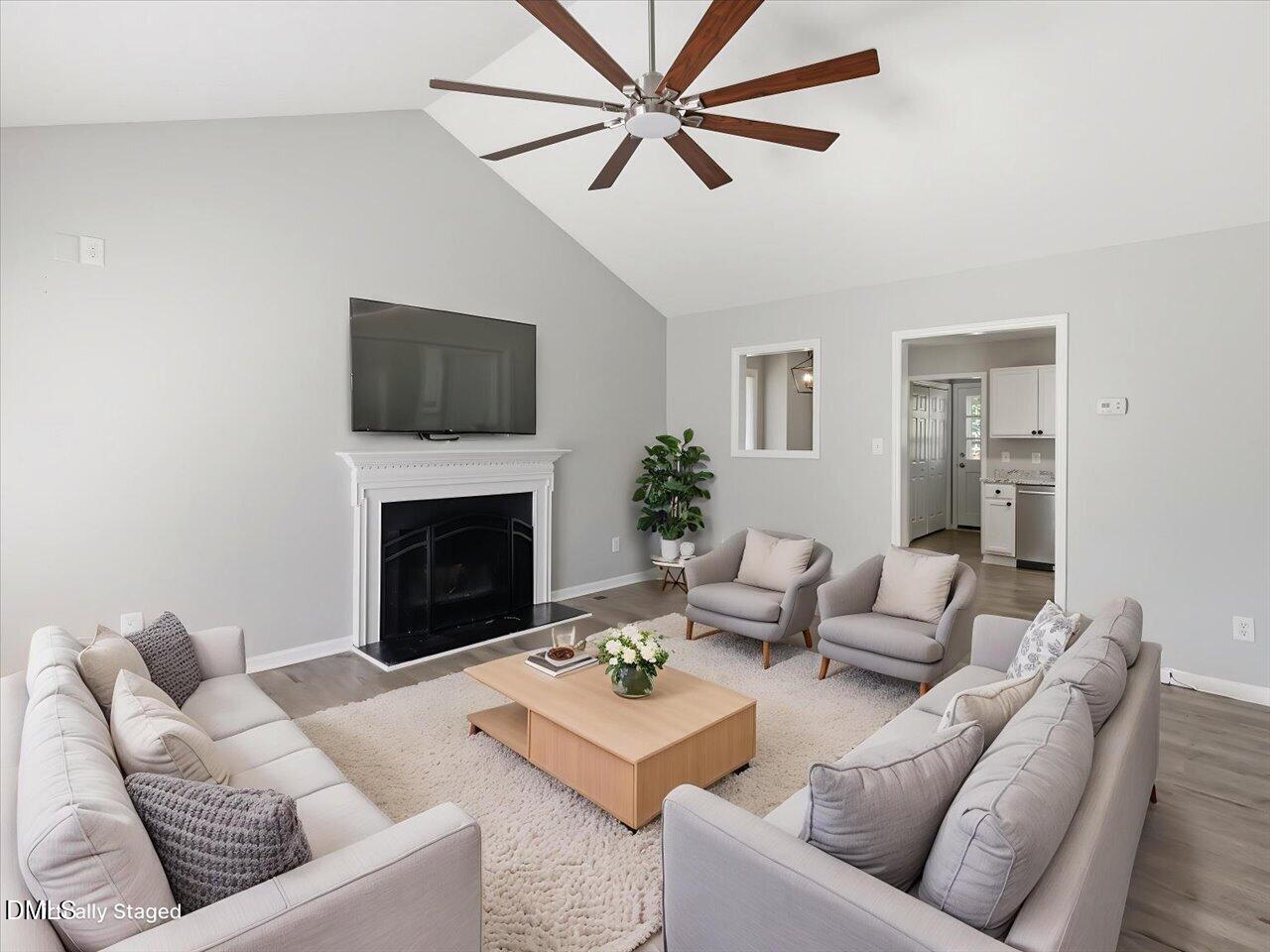 5 Jenee Lane Durham, NC 27703 - Photo 9 of 60 a living room with furniture a fireplace and a flat screen tv