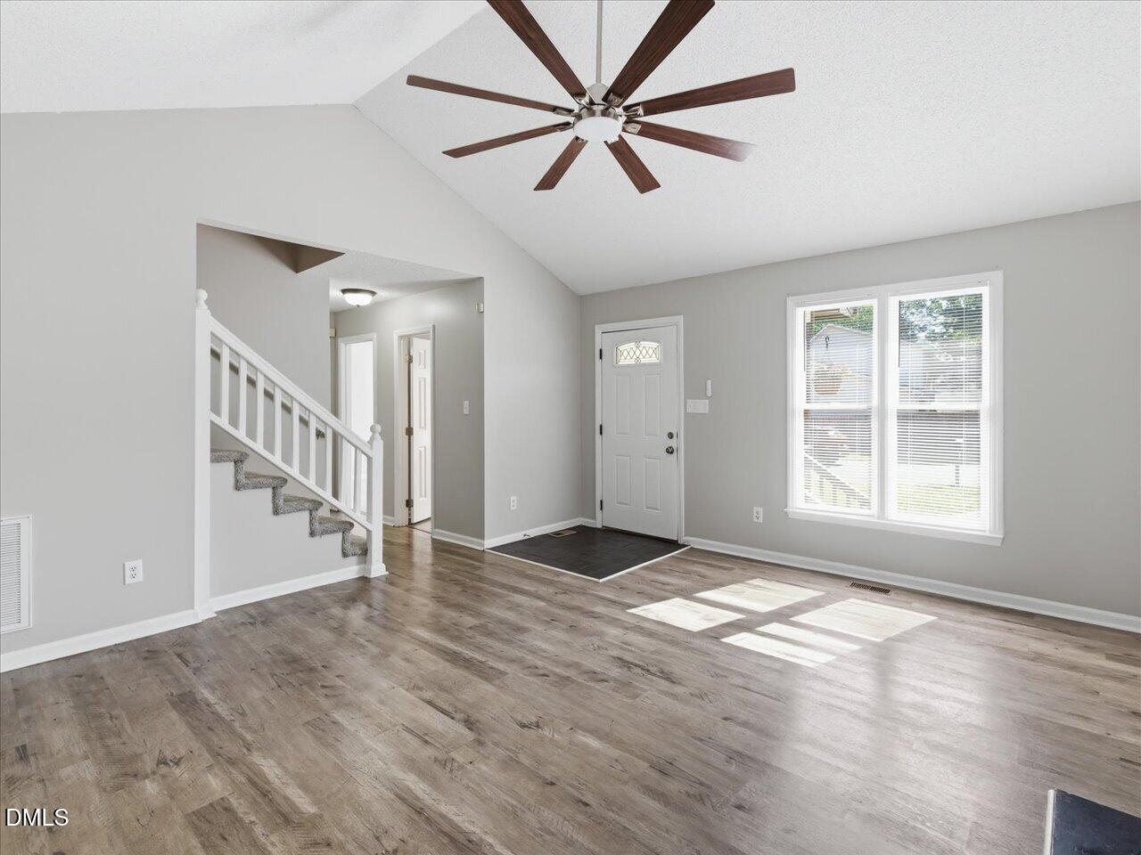 5 Jenee Lane Durham, NC 27703 - Photo 13 of 60 a view of an empty room with window and wooden floor
