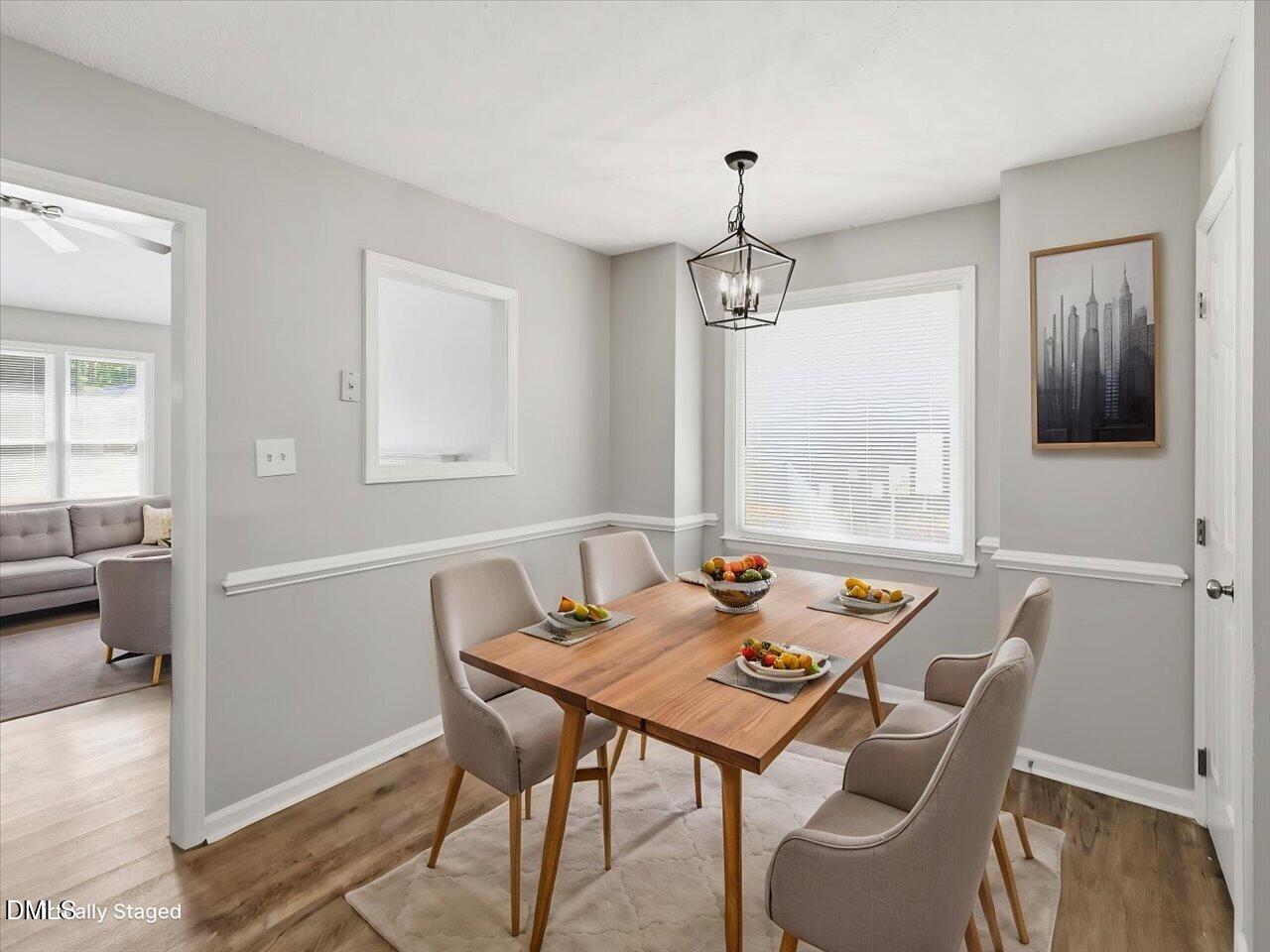 5 Jenee Lane Durham, NC 27703 - Photo 19 of 60 a view of a dining room with furniture window and wooden floor