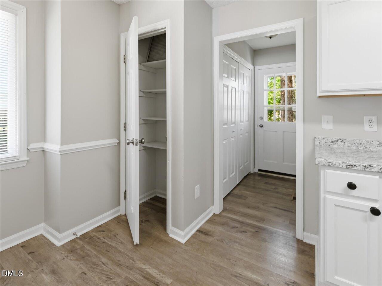 5 Jenee Lane Durham, NC 27703 - Photo 22 of 60 an empty room with wooden floor cabinet and windows