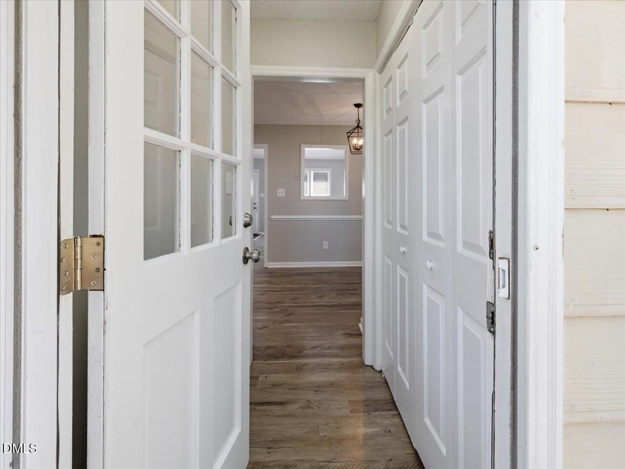 5 Jenee Lane Durham, NC 27703 - Photo 30 of 60 a view of a hallway with wooden floor and staircase