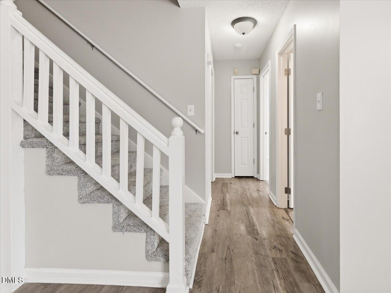 5 Jenee Lane Durham, NC 27703 - Photo 31 of 60 a view of a hallway with wooden floor and staircase