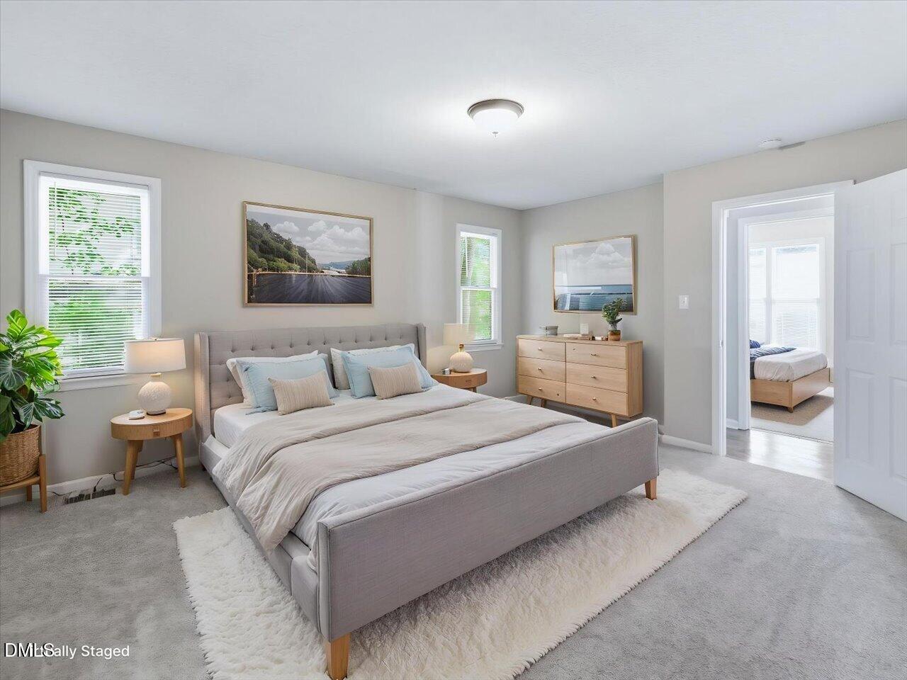 5 Jenee Lane Durham, NC 27703 - Photo 34 of 60 a spacious bedroom with a bed and a large mirror