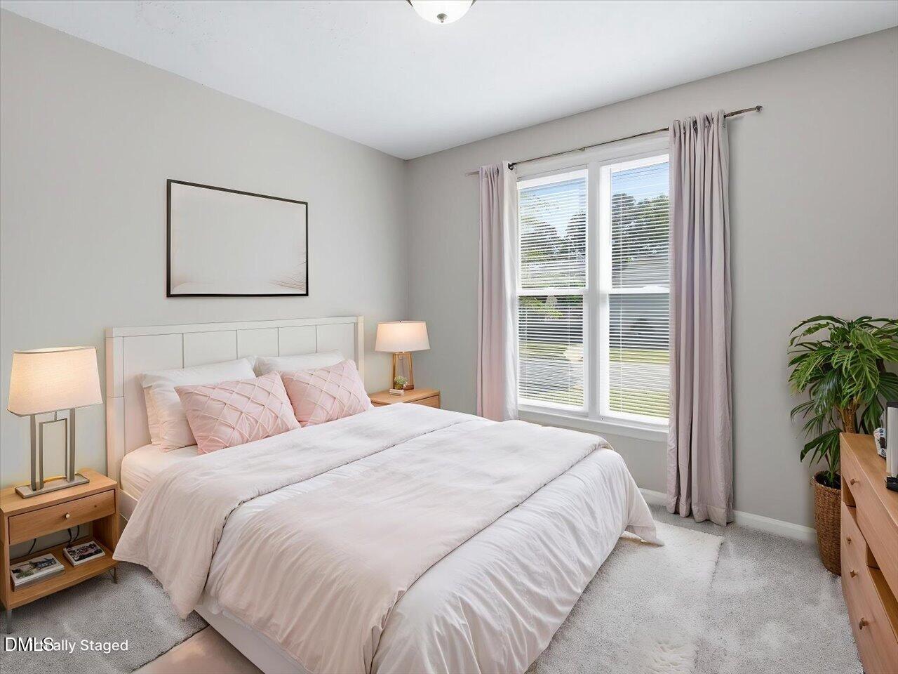 5 Jenee Lane Durham, NC 27703 - Photo 42 of 60 a bedroom with a bed and a window