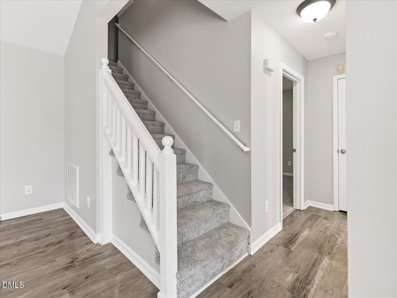 5 Jenee Lane Durham, NC 27703 - Photo 47 of 60 a view of a hallway with wooden floor and entryway