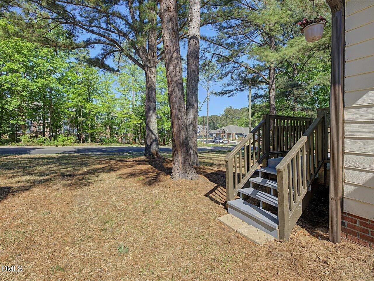 5 Jenee Lane Durham, NC 27703 - Photo 54 of 60 a view of a deck with a floor to ceiling window and wooden fence