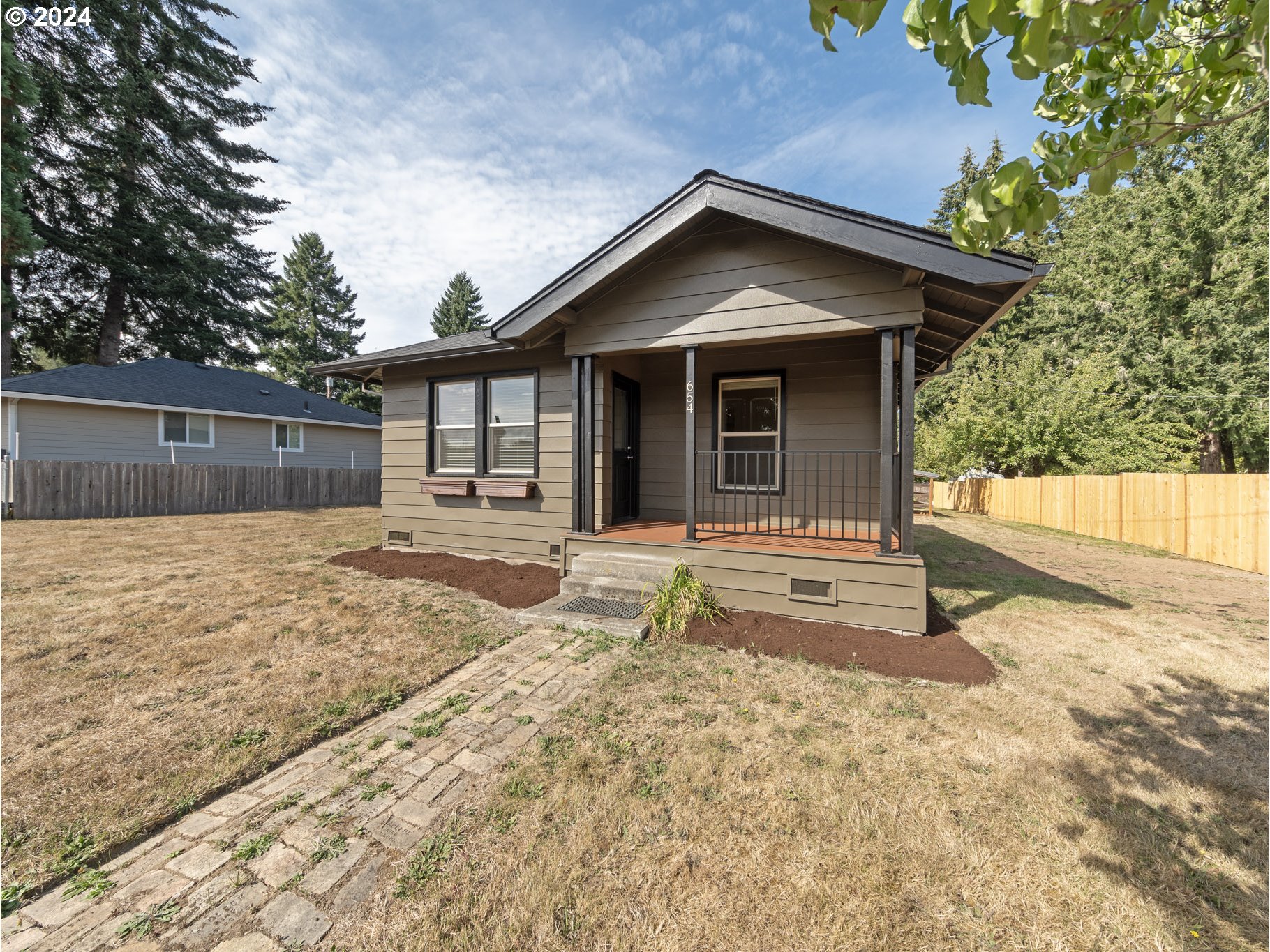 654 East Bridge Street Vernonia, OR 97064 - Photo 27 of 28 a house with trees in the background