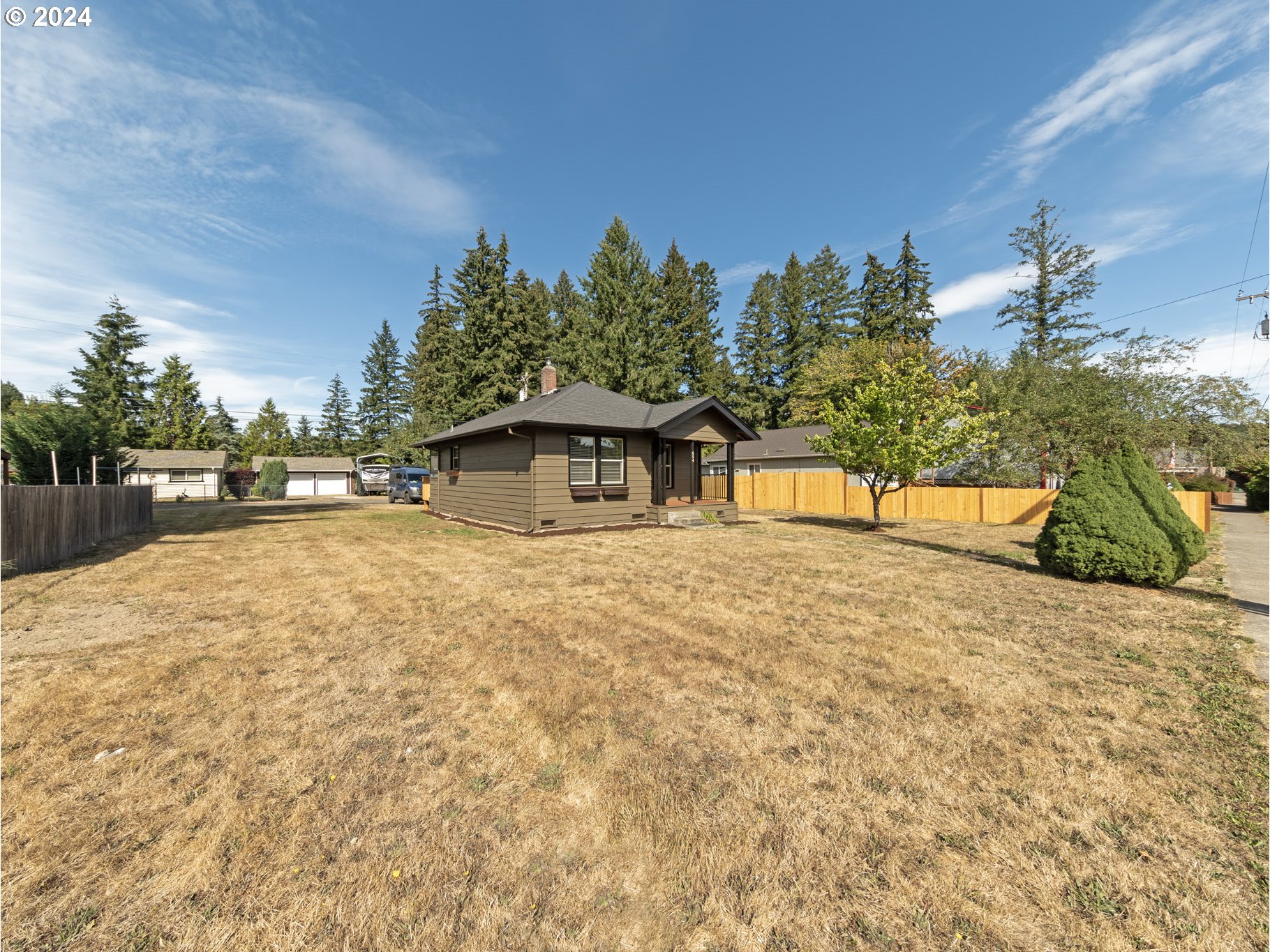 654 East Bridge Street Vernonia, OR 97064 - Photo 3 of 28 a house with trees in front of it
