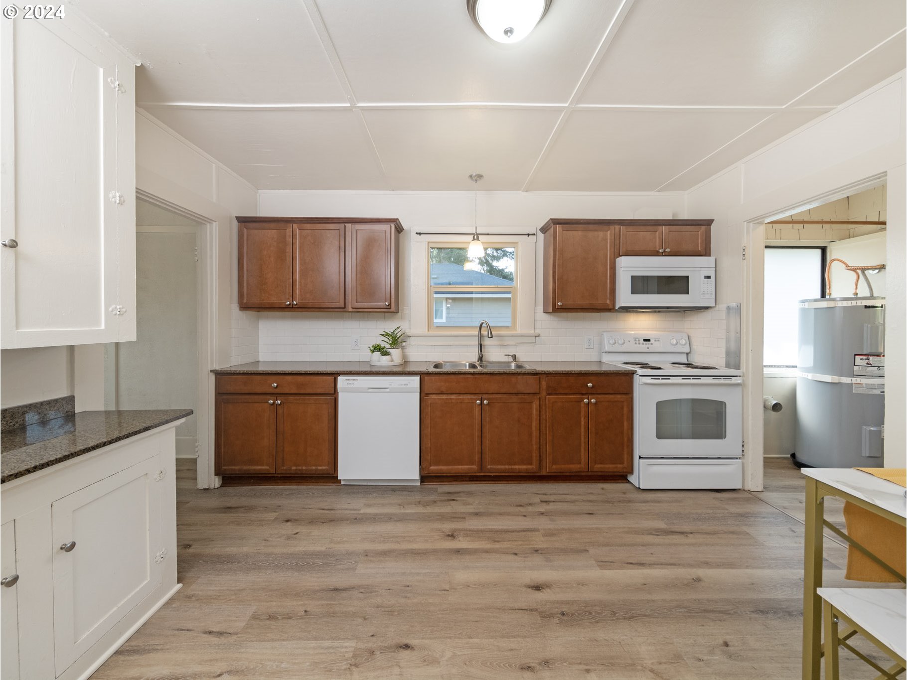 654 East Bridge Street Vernonia, OR 97064 - Photo 9 of 28 a large kitchen with stainless steel appliances granite countertop a sink counter space and cabinets