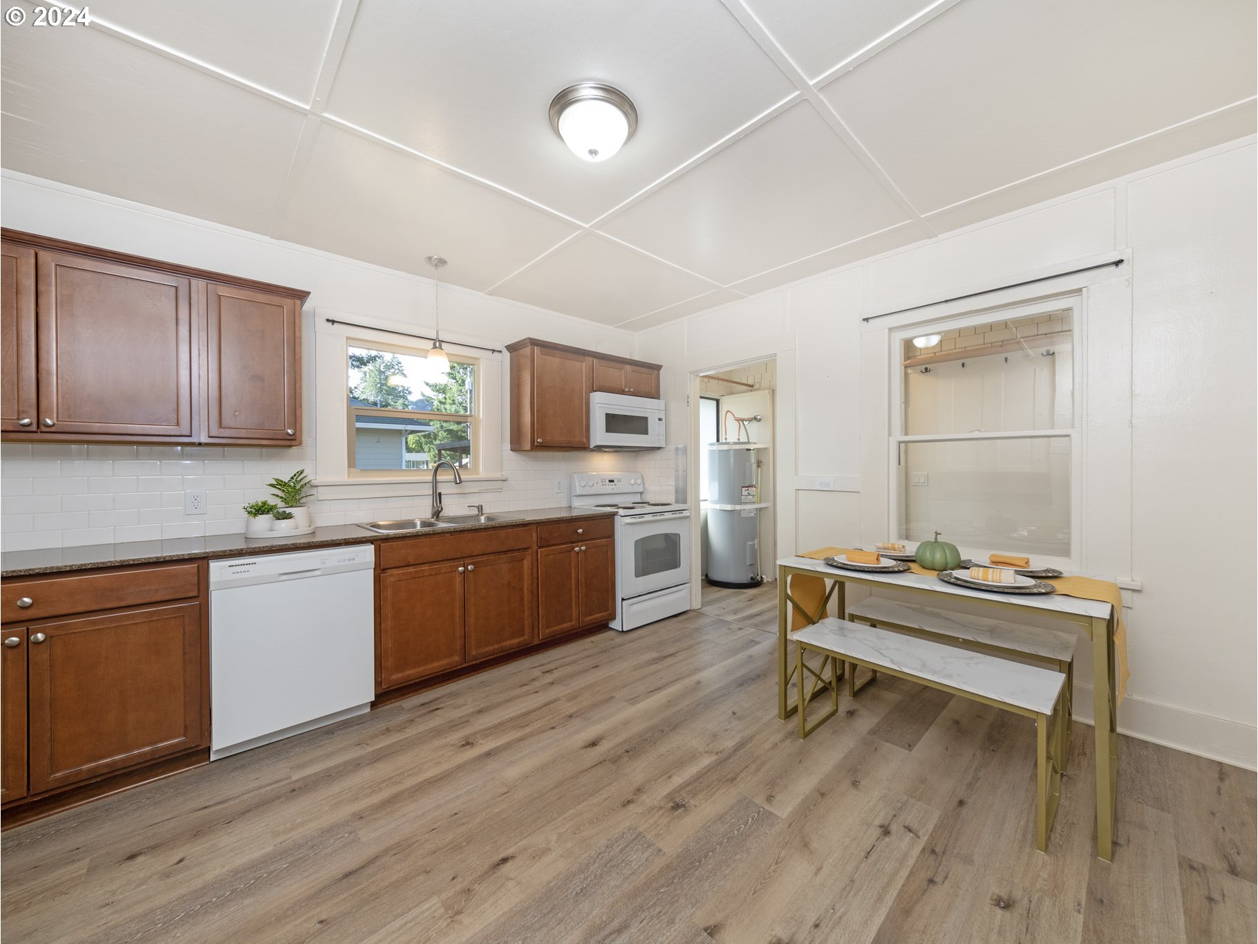 654 East Bridge Street Vernonia, OR 97064 - Photo 10 of 28 a kitchen with sink cabinets and wooden floor
