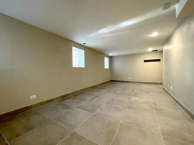 an empty room with a empty space and windows