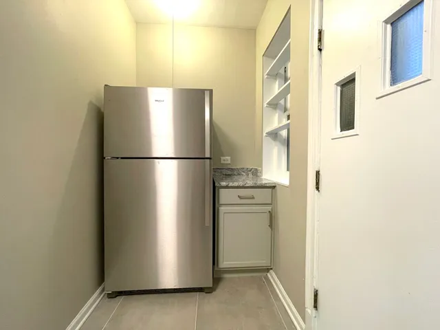 a white refrigerator freezer and a stove sitting inside of a kitchen