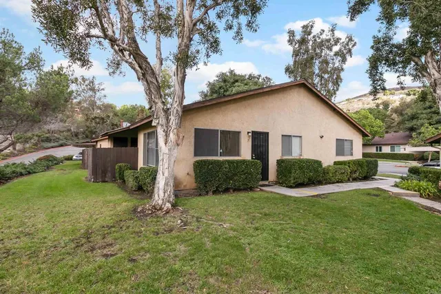 a view of house with yard