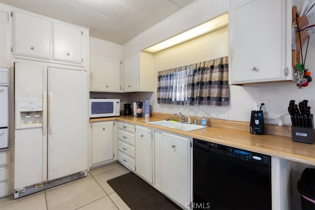 300 North Rampart Street, Unit 195 Orange, CA 92868 - Photo 3 of 25 a kitchen with a sink cabinets and window