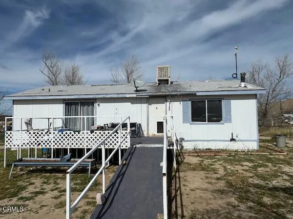 a view of a house with a wooden deck