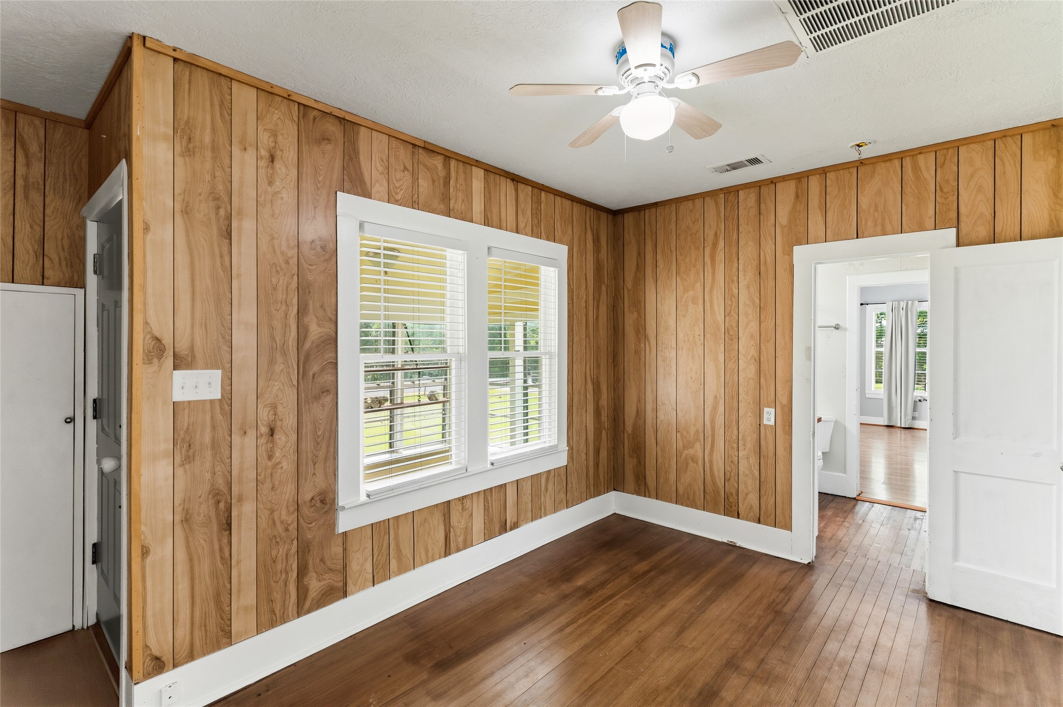 12903 Sandpiper Road Angleton, TX 77515 - Photo 5 of 19 The living room (14x9) offers a comfortable place to relax after a day on the water, with original hardwood floors and plenty of natural light.