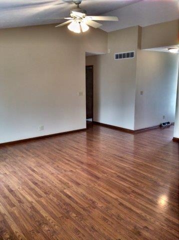 992 South Trainer Road Rockford, IL 61108 - Photo 12 of 15 a view of an empty room with wooden floor and a ceiling fan