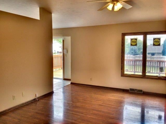 992 South Trainer Road Rockford, IL 61108 - Photo 5 of 15 an empty room with wooden floor and windows