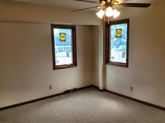 992 South Trainer Road Rockford, IL 61108 - Photo 9 of 15 an empty room with window and chandelier fan