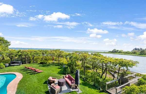 a view of yard with swimming pool and green space
