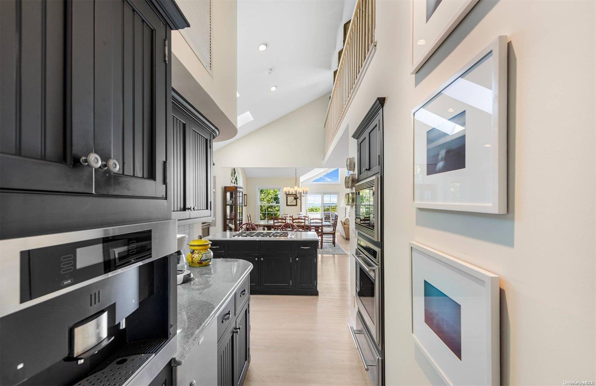 134 Middle Pond Road Southampton, NY 11968 - Photo 16 of 32 a kitchen with stainless steel appliances kitchen island granite countertop a refrigerator a stove and a sink with cabinets