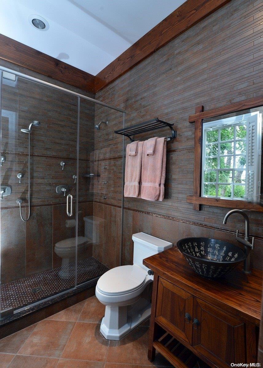 134 Middle Pond Road Southampton, NY 11968 - Photo 24 of 32 a bathroom with a sink a toilet and shower