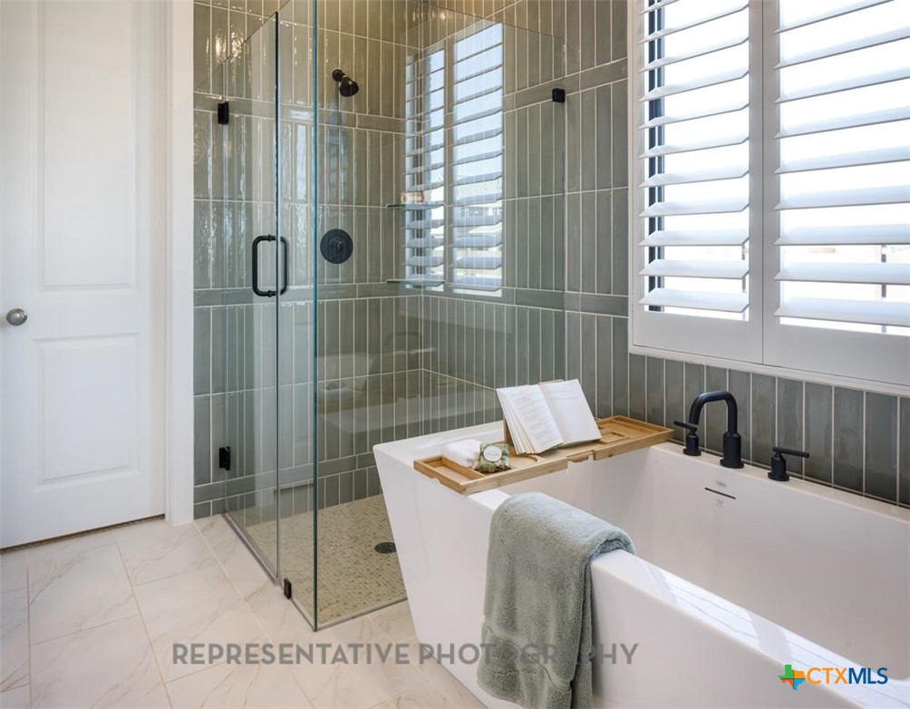 9212 Boathouse Drive Austin, TX 78744 - Photo 21 of 40 a bathroom with a sink and a shower
