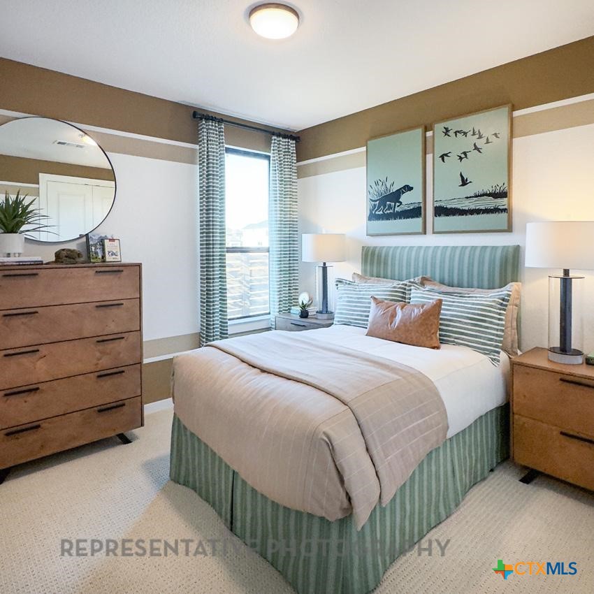 9212 Boathouse Drive Austin, TX 78744 - Photo 36 of 40 a bedroom with a bed a window and painting on the wall