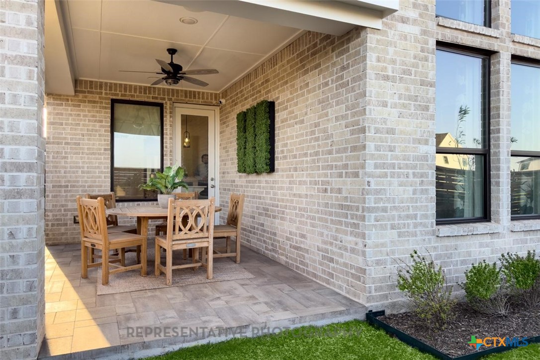 9212 Boathouse Drive Austin, TX 78744 - Photo 39 of 40 a patio with table and chairs and potted plants