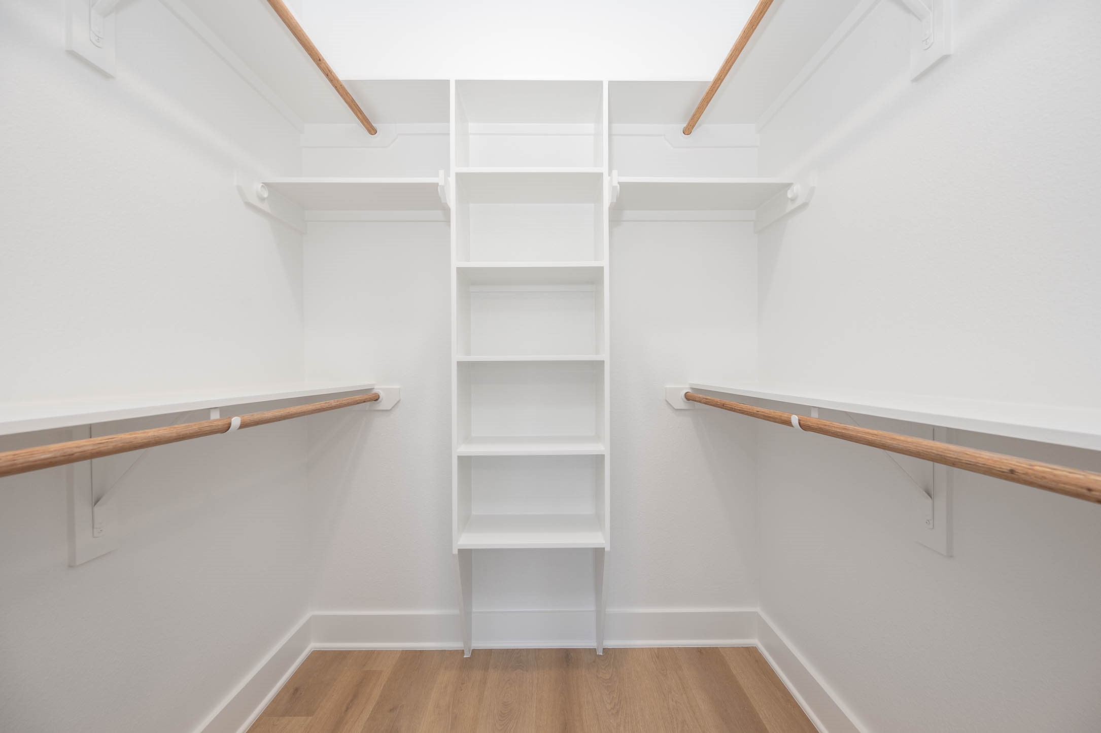 8602 Hoffman Street Houston, TX 77016 - Photo 22 of 30 Spacious walk-in closet featuring built-in shelving and dual hanging rods for effortless organization.