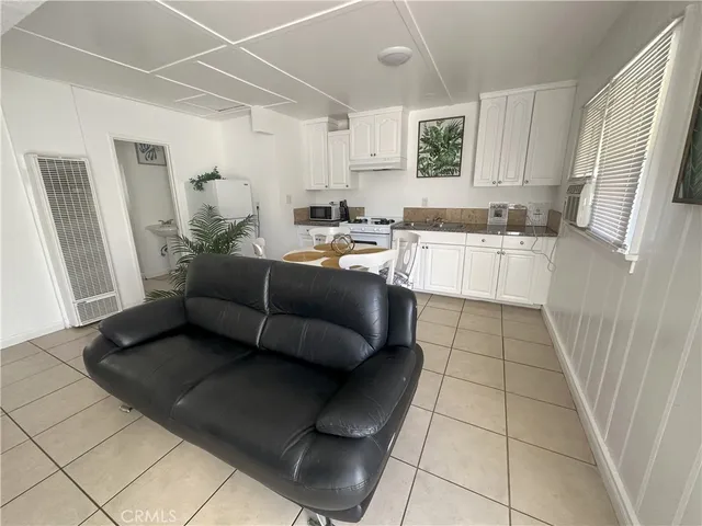 a living room with a couch and a stove top oven