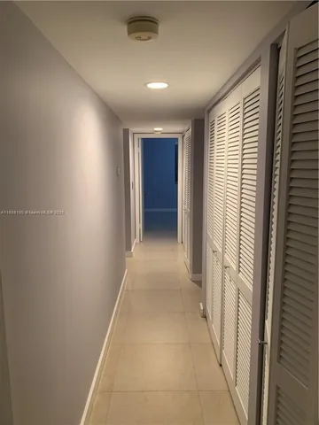 a view of hallway with window and stairs