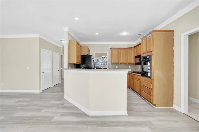 a large kitchen with cabinets and stainless steel appliances